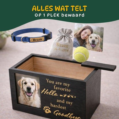 Zwarte hondenurn met schuifdeksel waarin een foto, halsband, herinneringszakje en speeltje samen worden bewaard als blijvende herinnering aan een hond